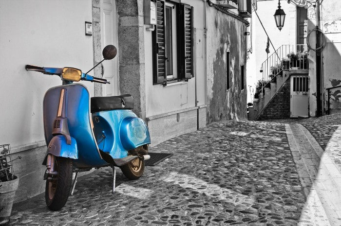 Moped in cobblestone alley, Italy