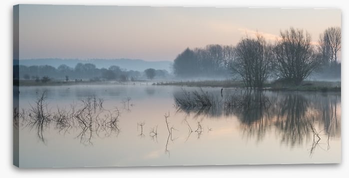 Sunrise glow over misty lake