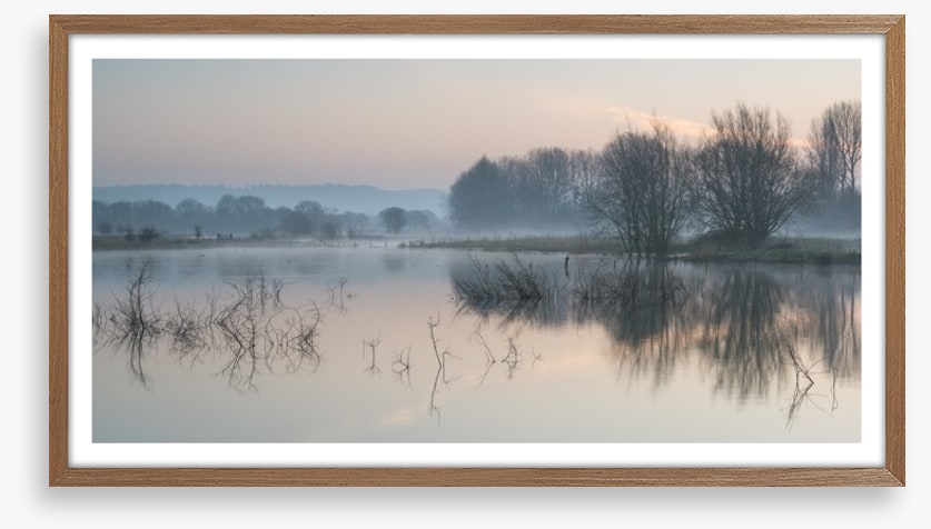 Sunrise glow over misty lake