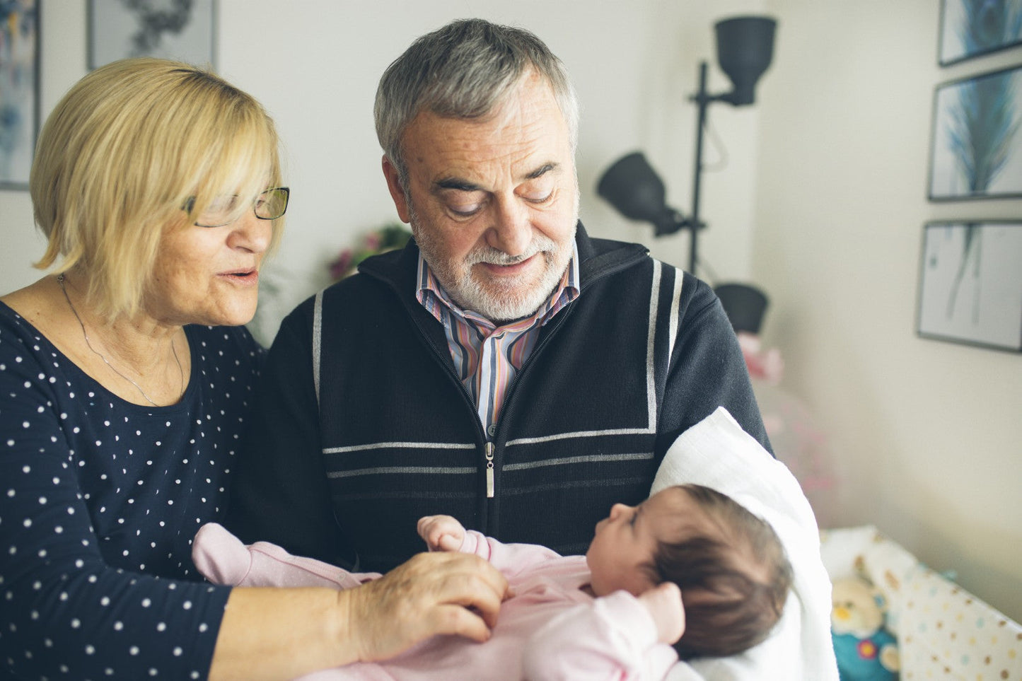 Grandparents holding baby