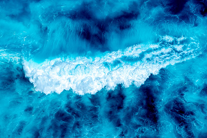 drone photography of a blue wave