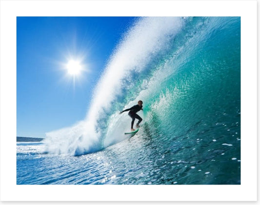 Surfer on blue ocean wave