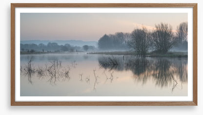 Sunrise glow over misty lake