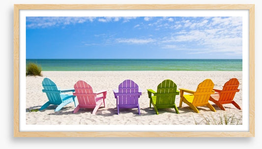 Rainbow chairs on a sunny beach