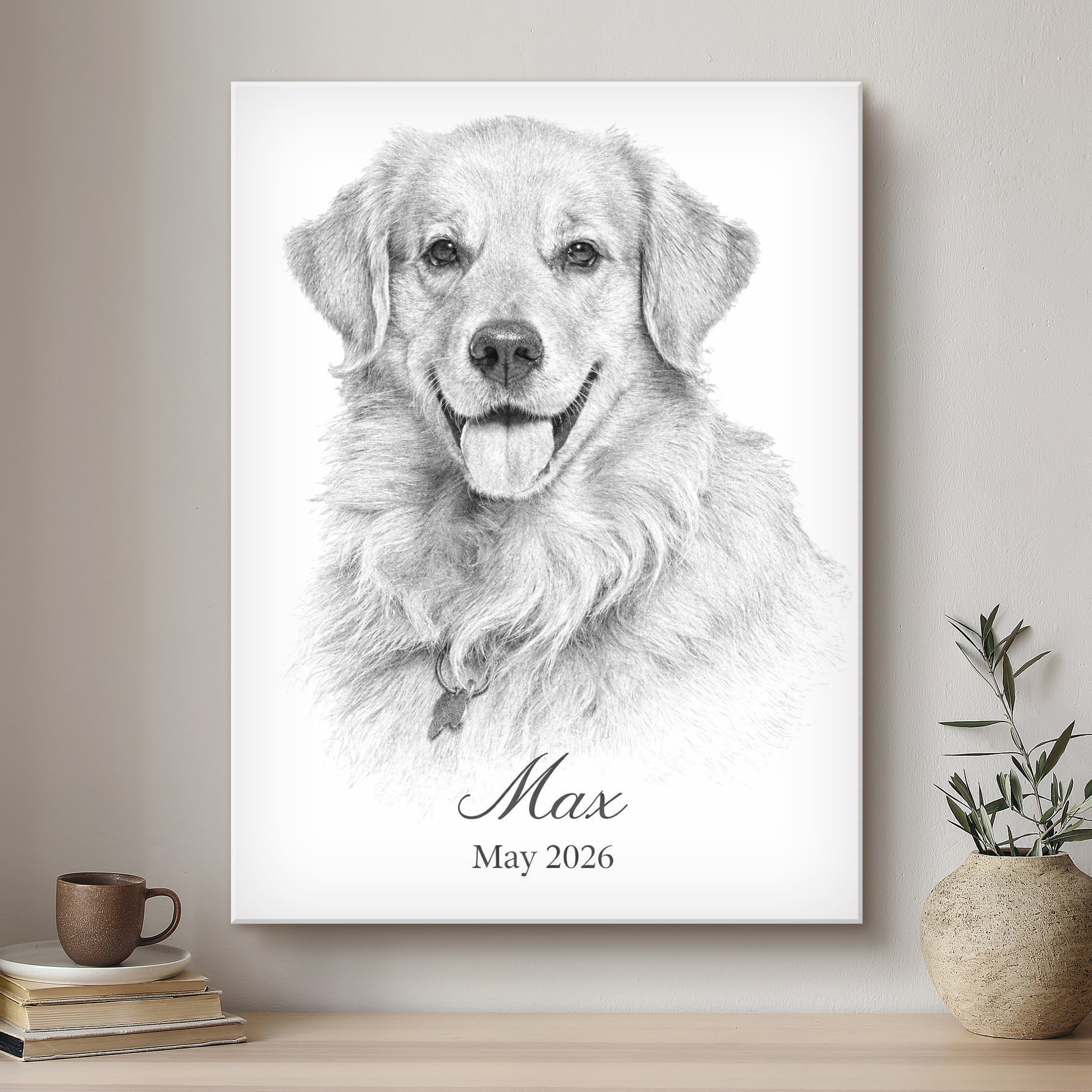 Framed black and white portrait of a dog named Max with a date, on a wall above a shelf with books and a plant.