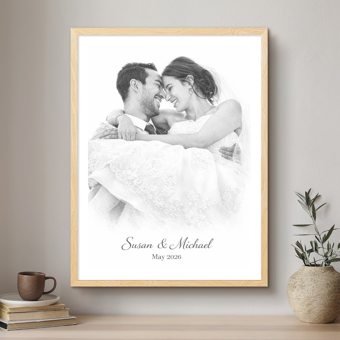 Framed black and white photo of a couple with 'Susan & Michael May 2026' text on a wall above a shelf.