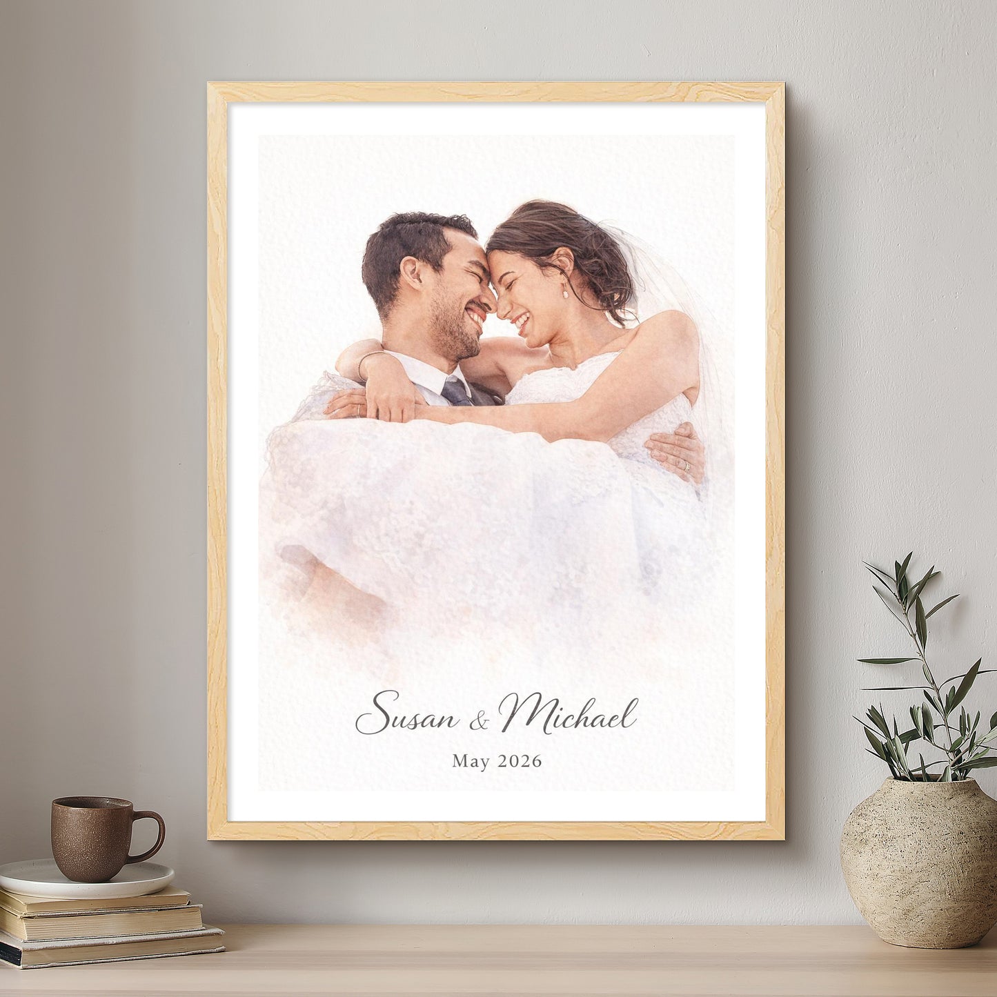 Framed photograph of a couple with 'Susan & Michael' and 'May 2026' text on a wall above a shelf.