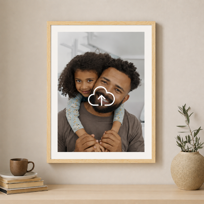 Framed photo of a man and child on a shelf with a plant and books.