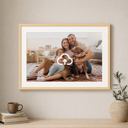 Framed family photo with a dog on a wall in a home setting