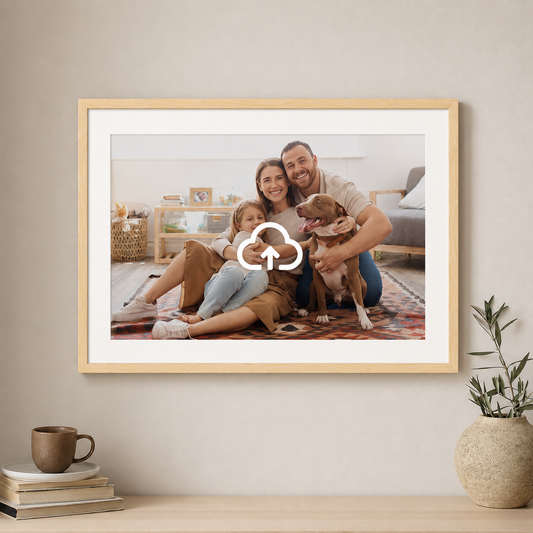 Framed family photo with a dog on a wall in a home setting