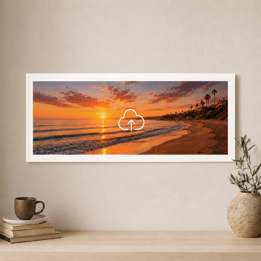 Framed beach sunset print on a wall with a cup and books below.